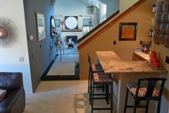 Wet Bar, Entry, Stairs to Second Floor, and View to Living Room Fire Place